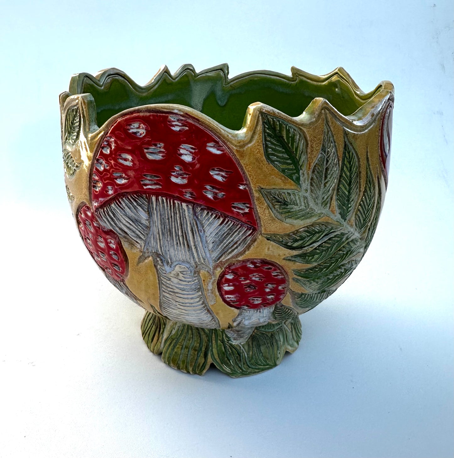 Large bowl with Amanita mushrooms, ferns, and hearts