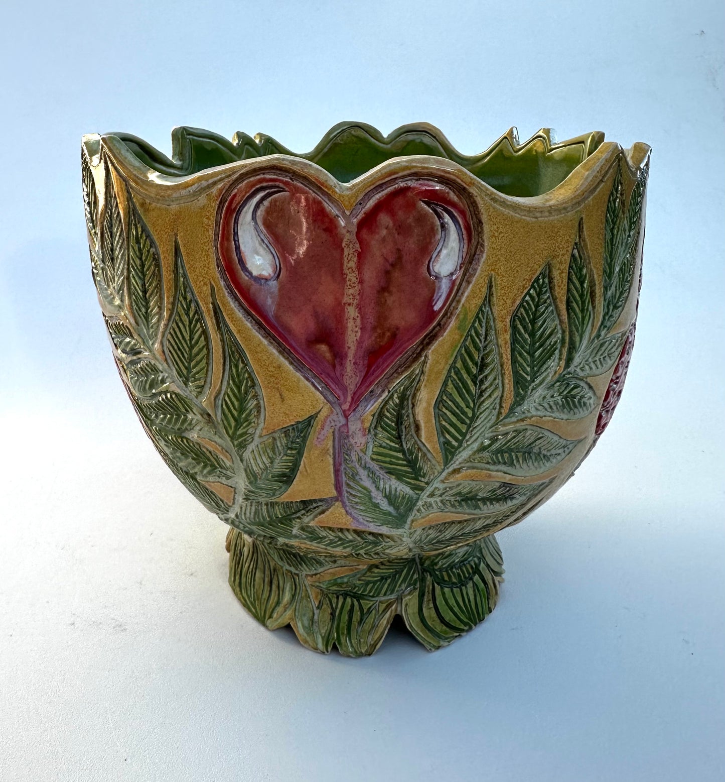 Large bowl with Amanita mushrooms, ferns, and hearts