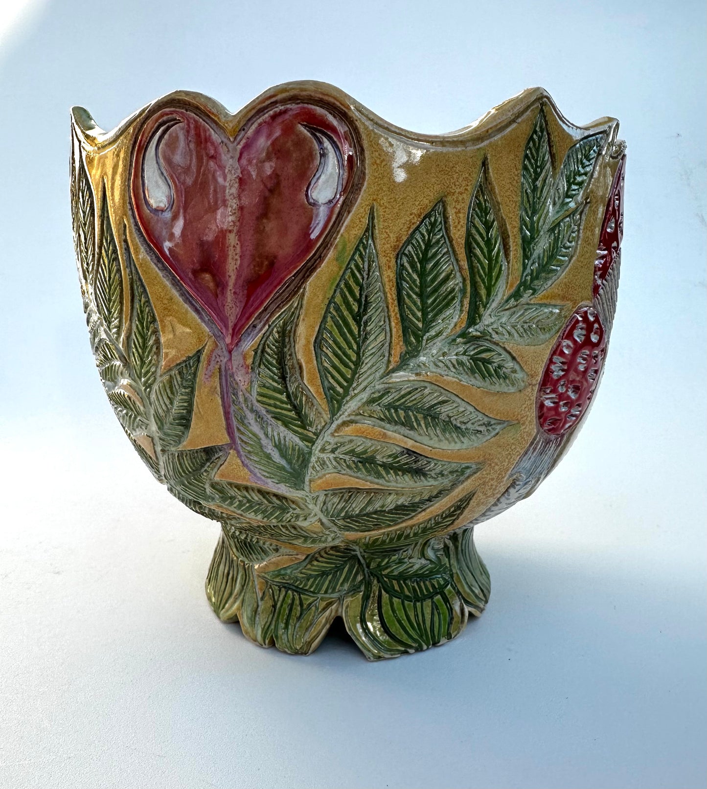 Large bowl with Amanita mushrooms, ferns, and hearts