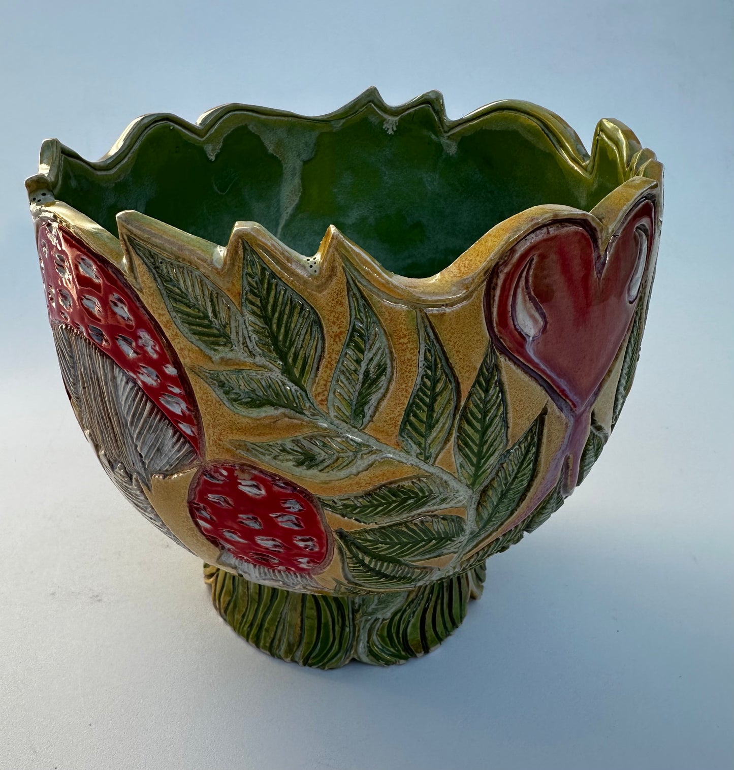 Large bowl with Amanita mushrooms, ferns, and hearts