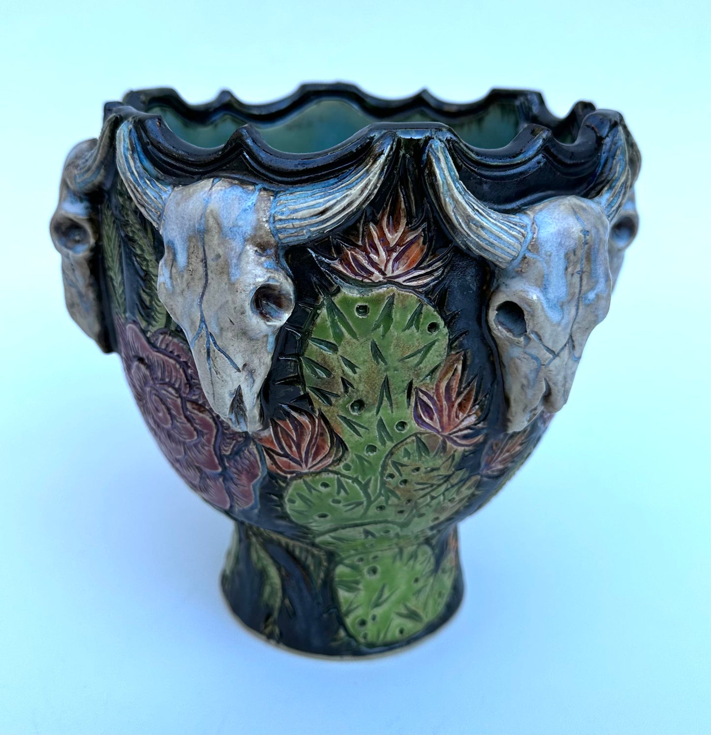Bowl with steer skulls, roses, and cactuses