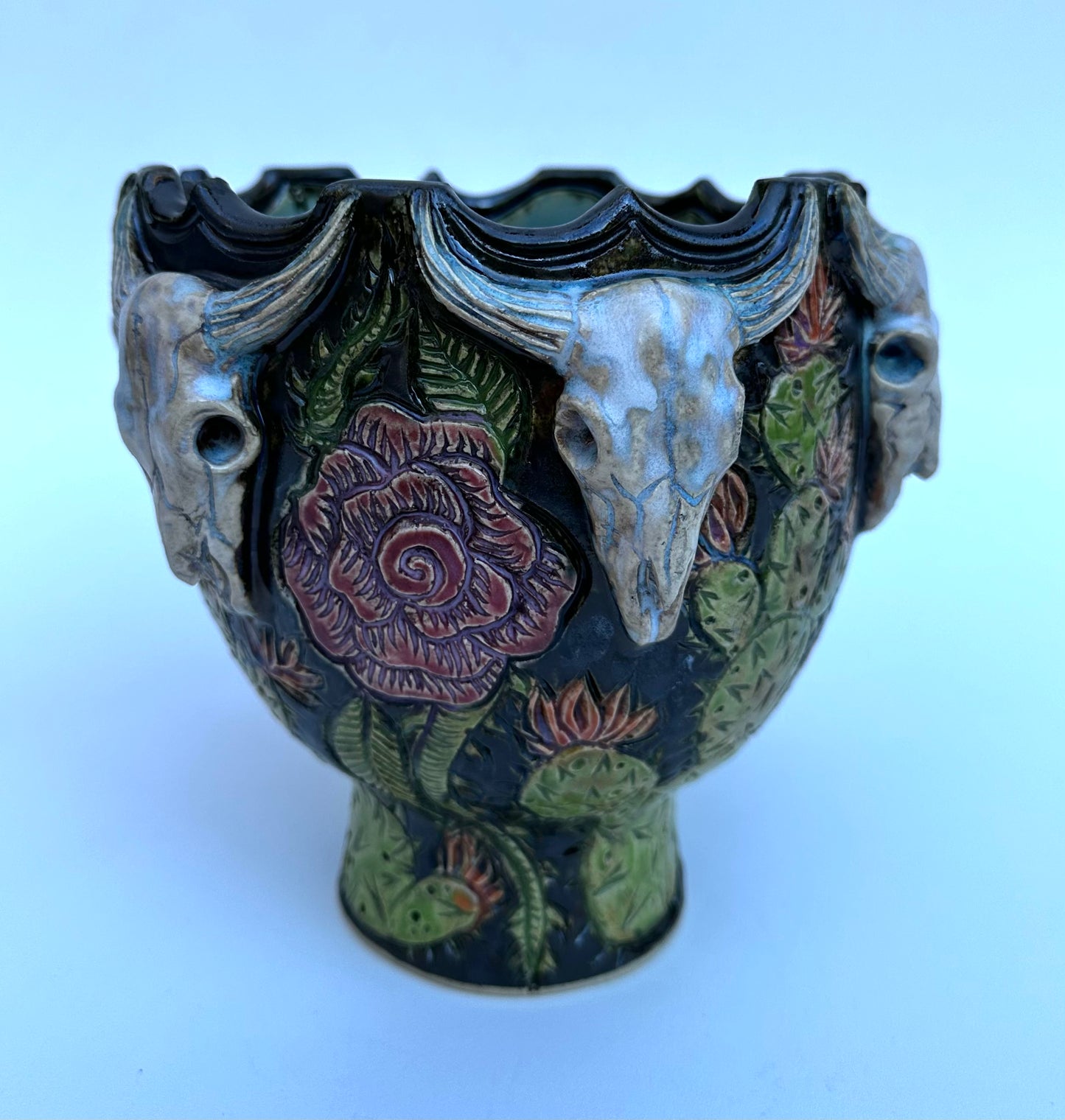 Bowl with steer skulls, roses, and cactuses