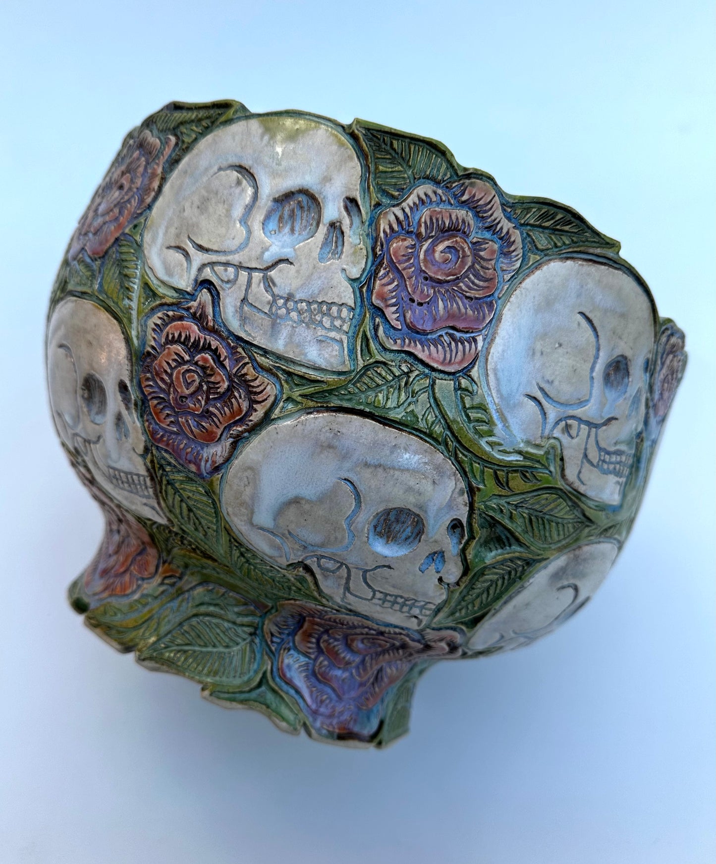 Large hand carved serving bowl with skulls and roses