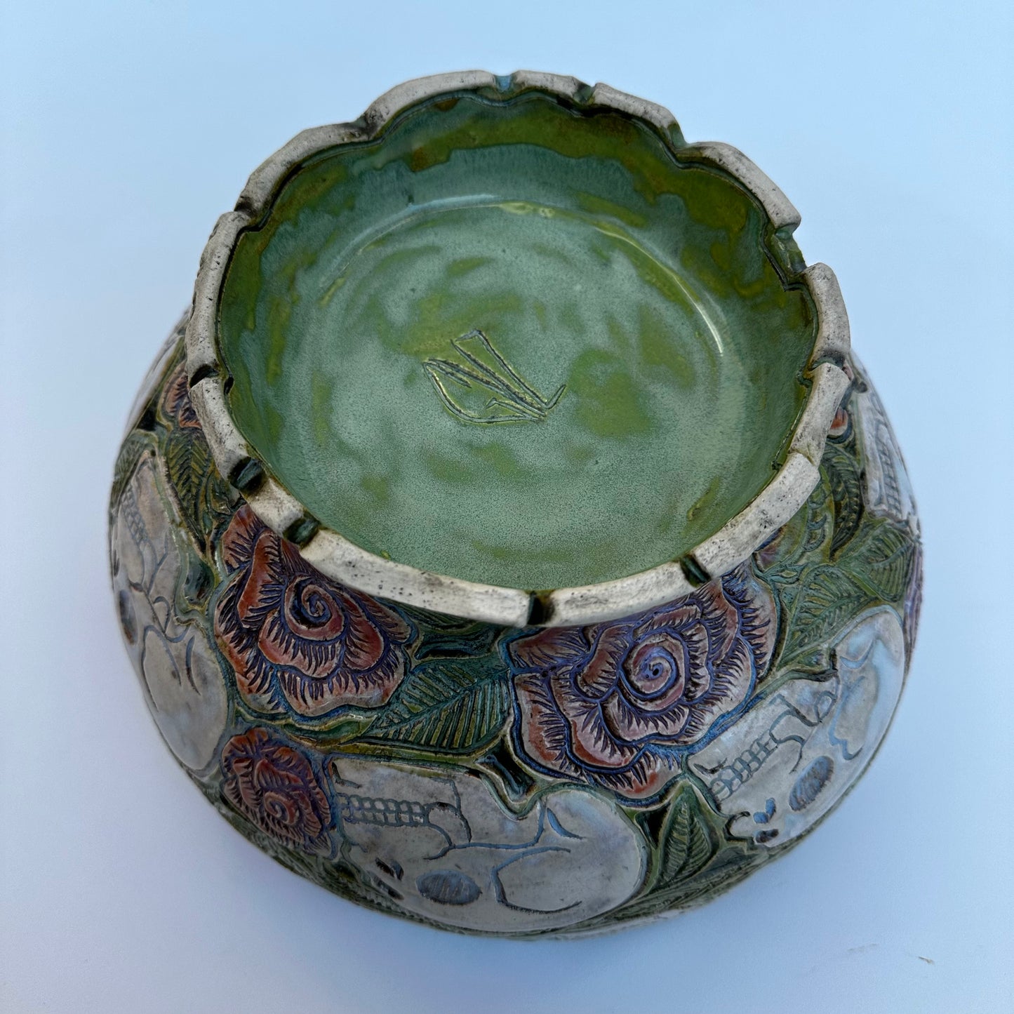 Large hand carved serving bowl with skulls and roses