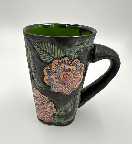 Black mug with carved Roses