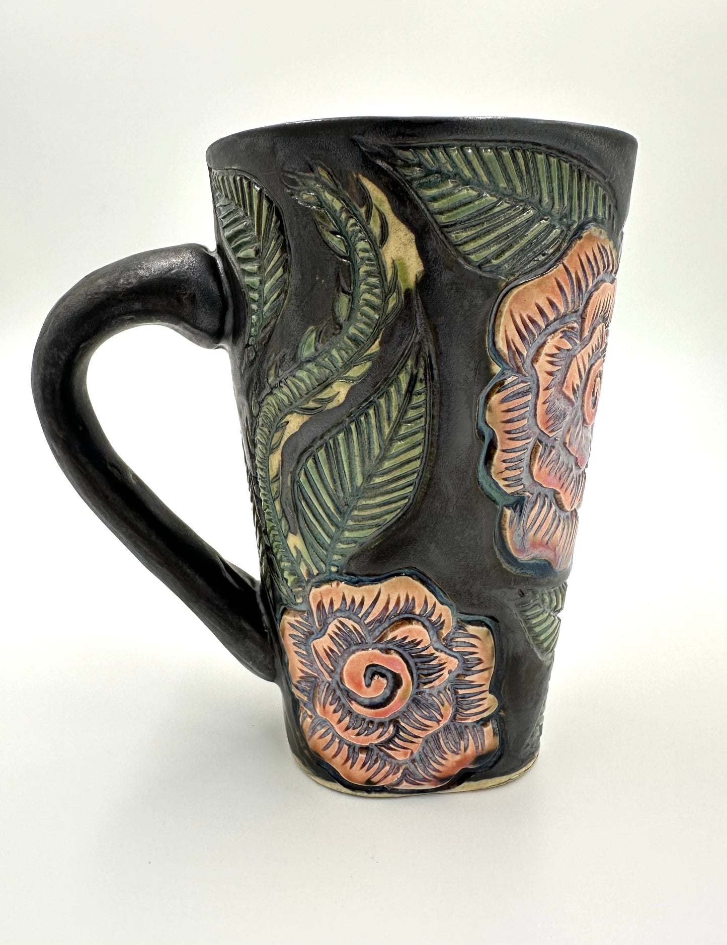 Black mug with carved Roses