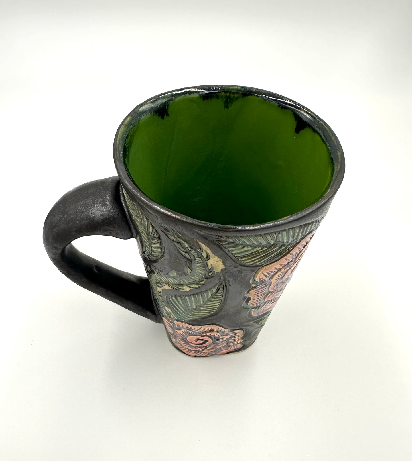 Black mug with carved Roses