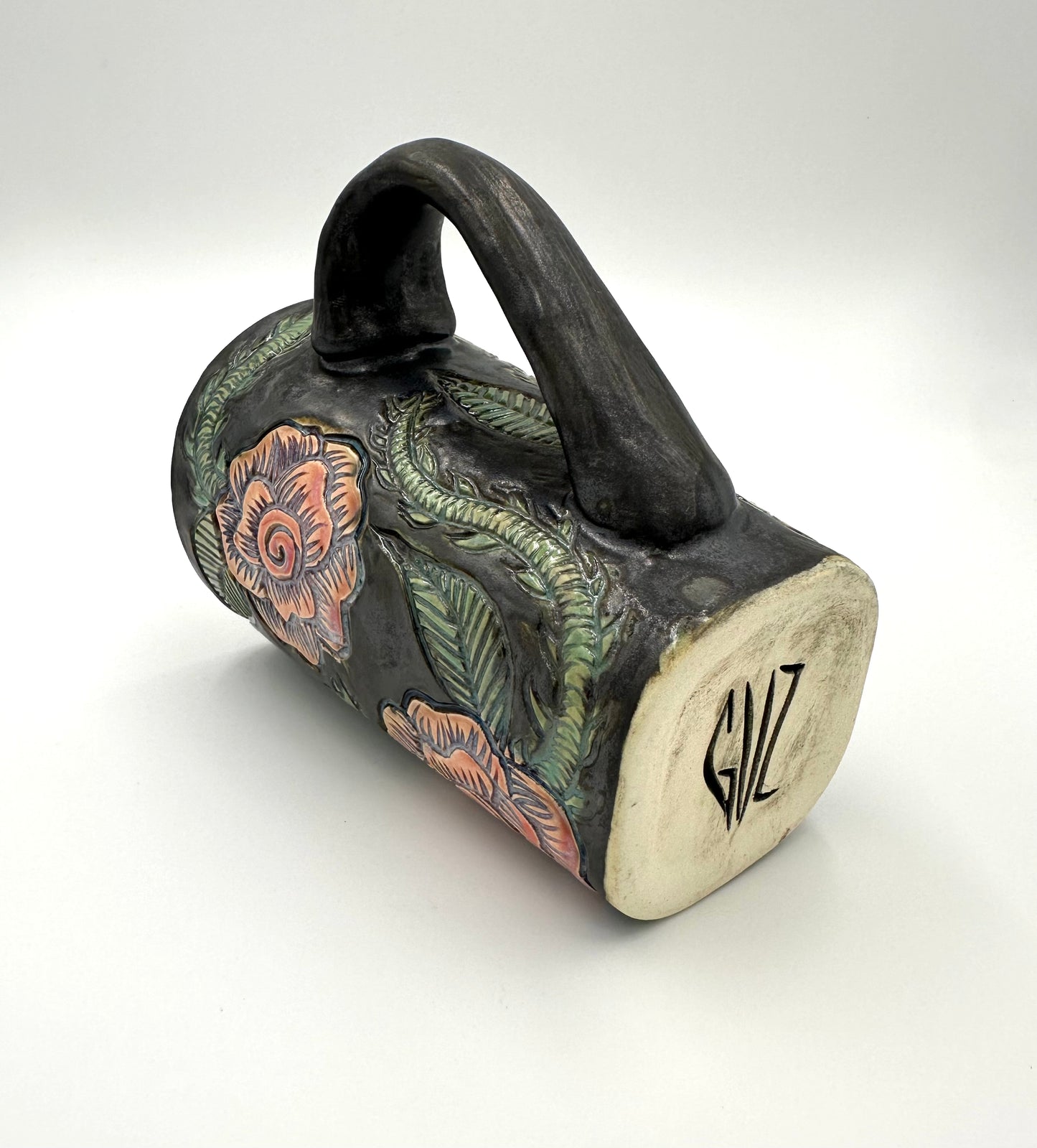 Black mug with carved Roses