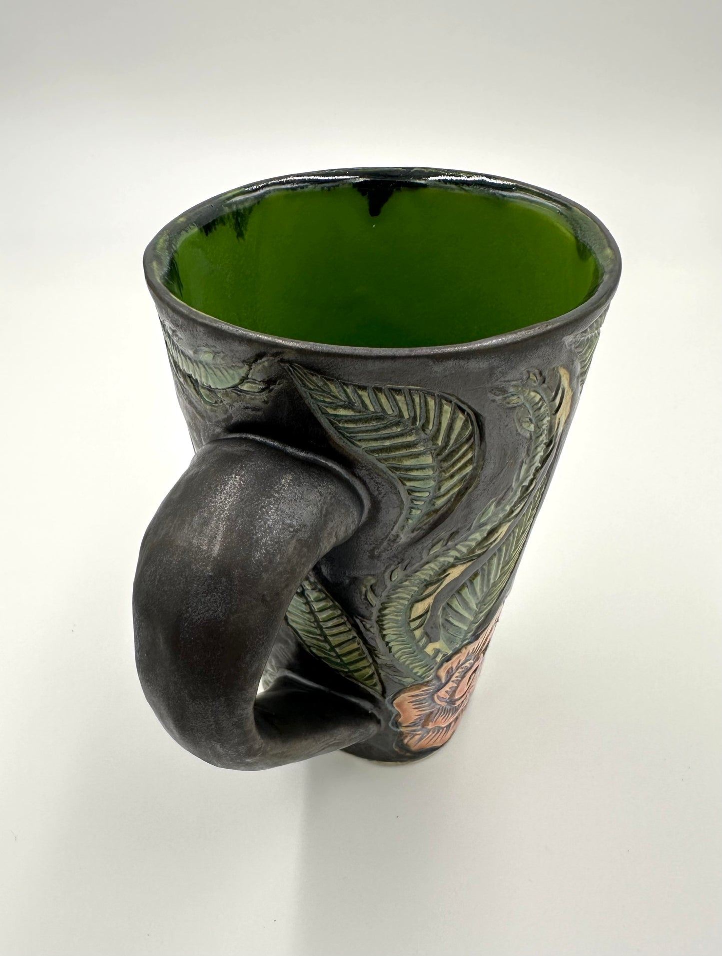 Black mug with carved Roses