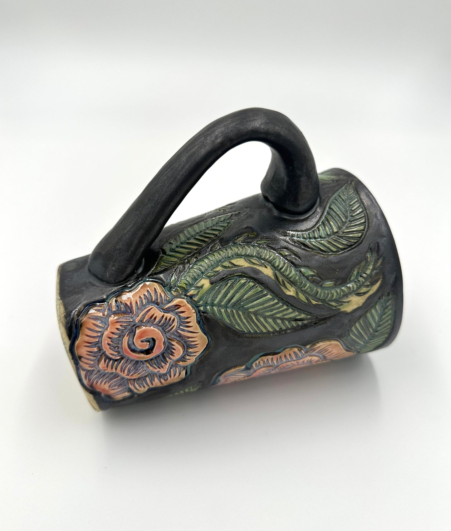 Black mug with carved Roses