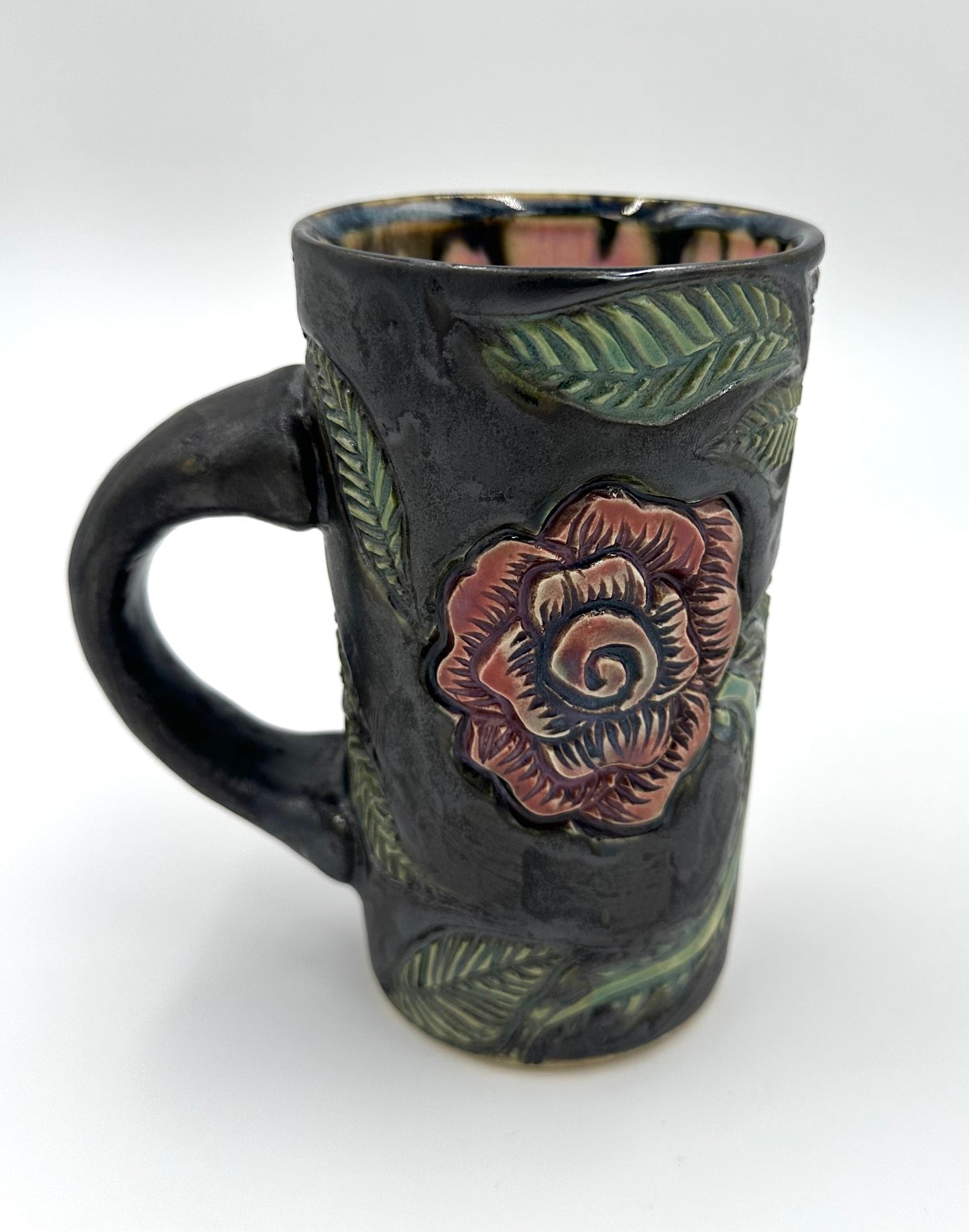 Black mug with carved Roses