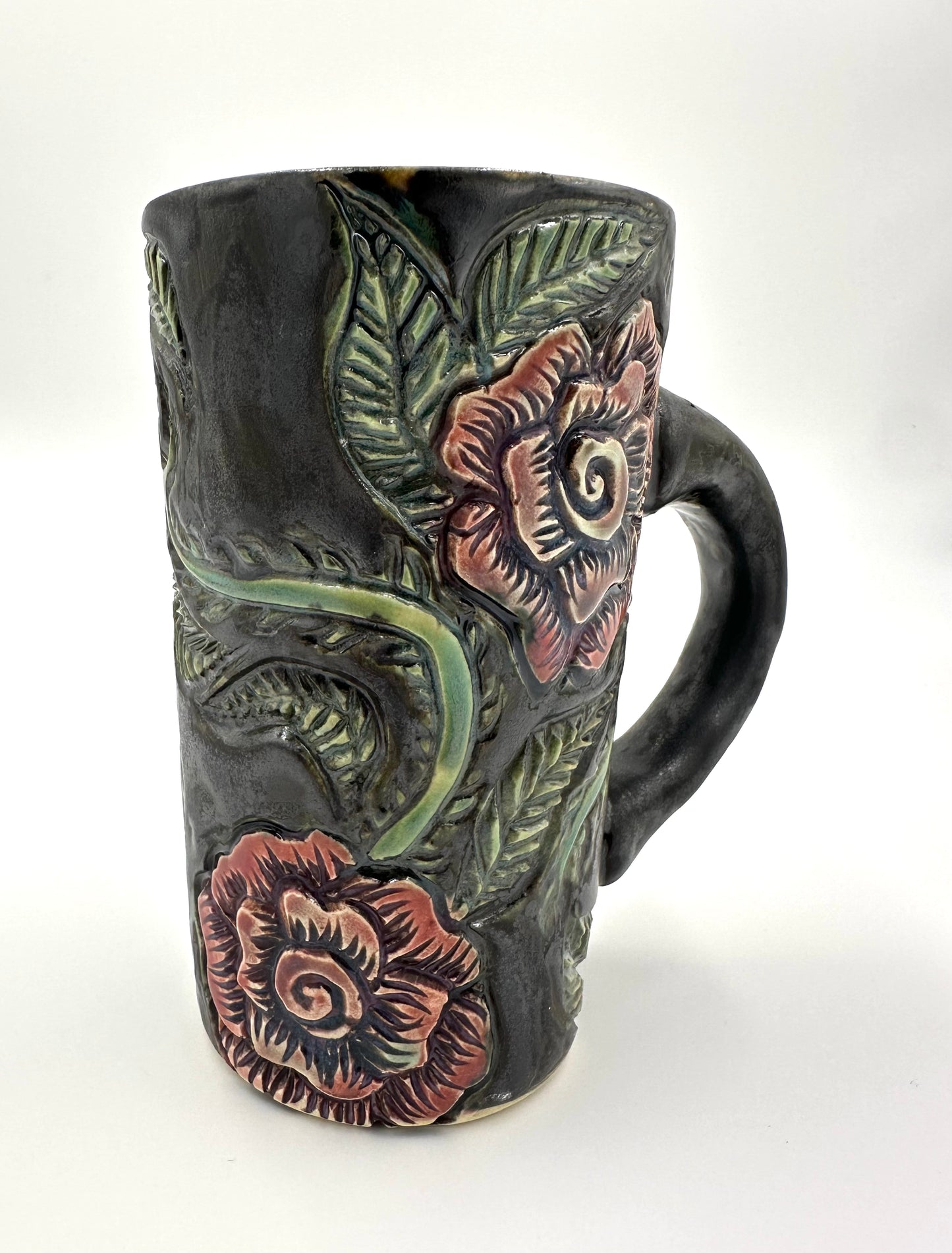 Black mug with carved Roses