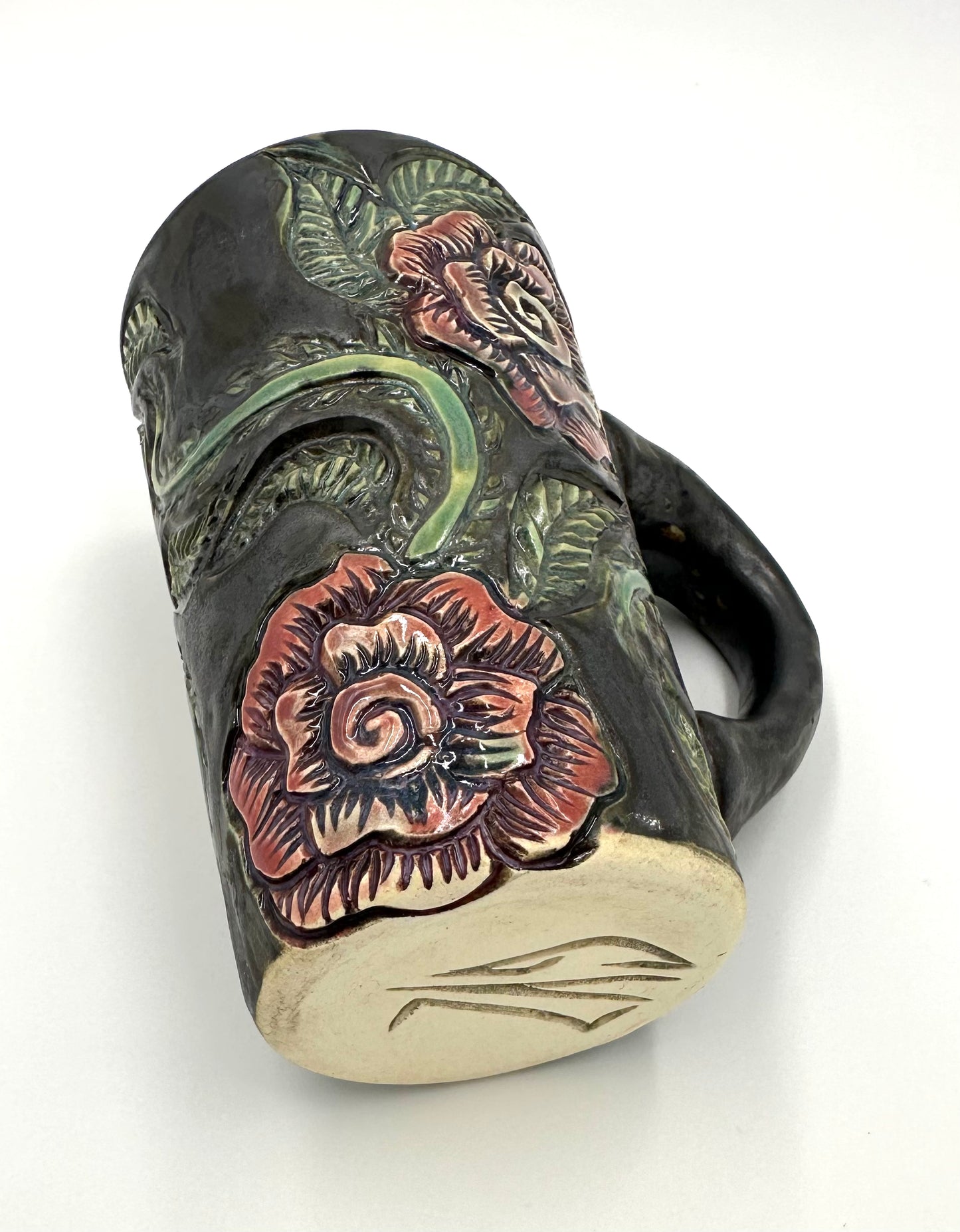 Black mug with carved Roses