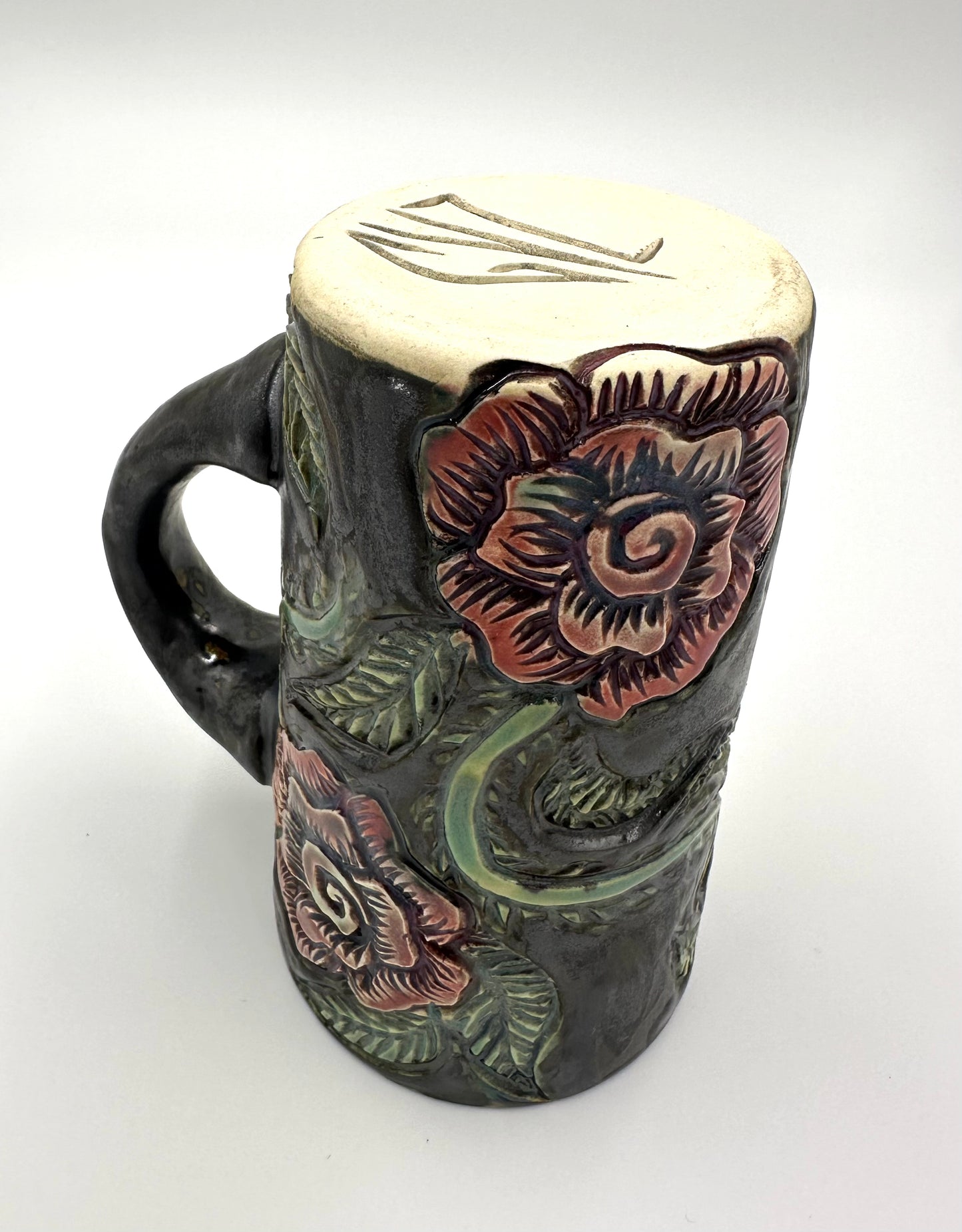 Black mug with carved Roses