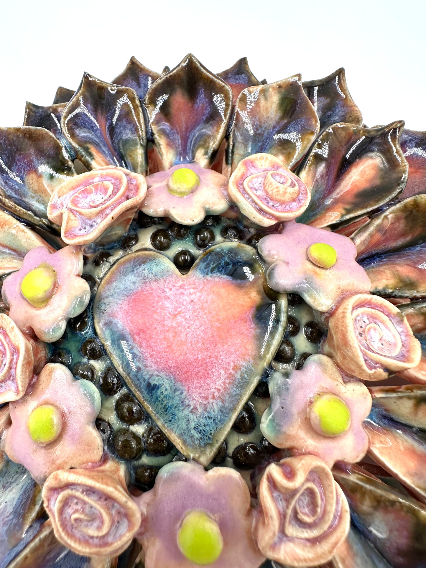 Purple and black heart zinnia wall hanging ceramic sculpture